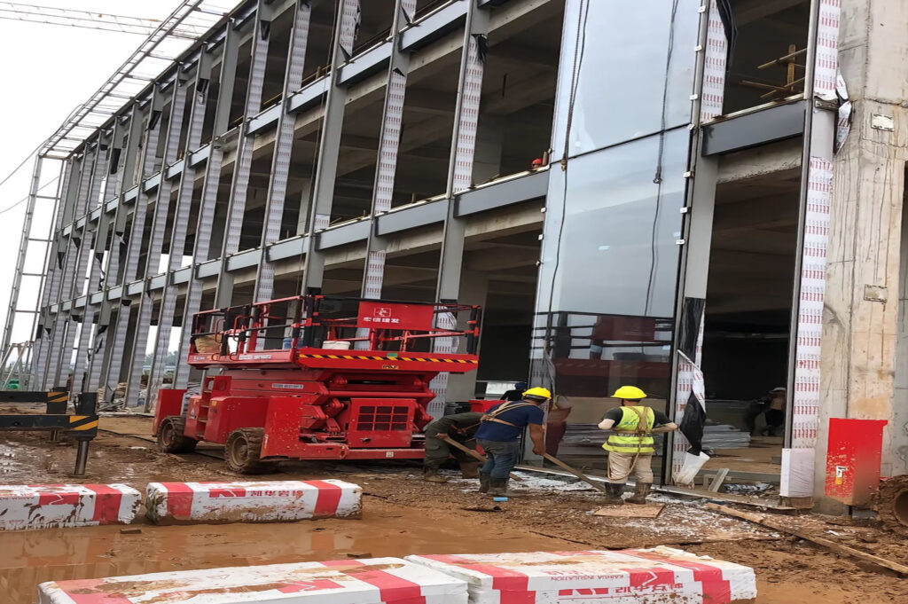 High-rise curtain wall glass installation with lifting equipment