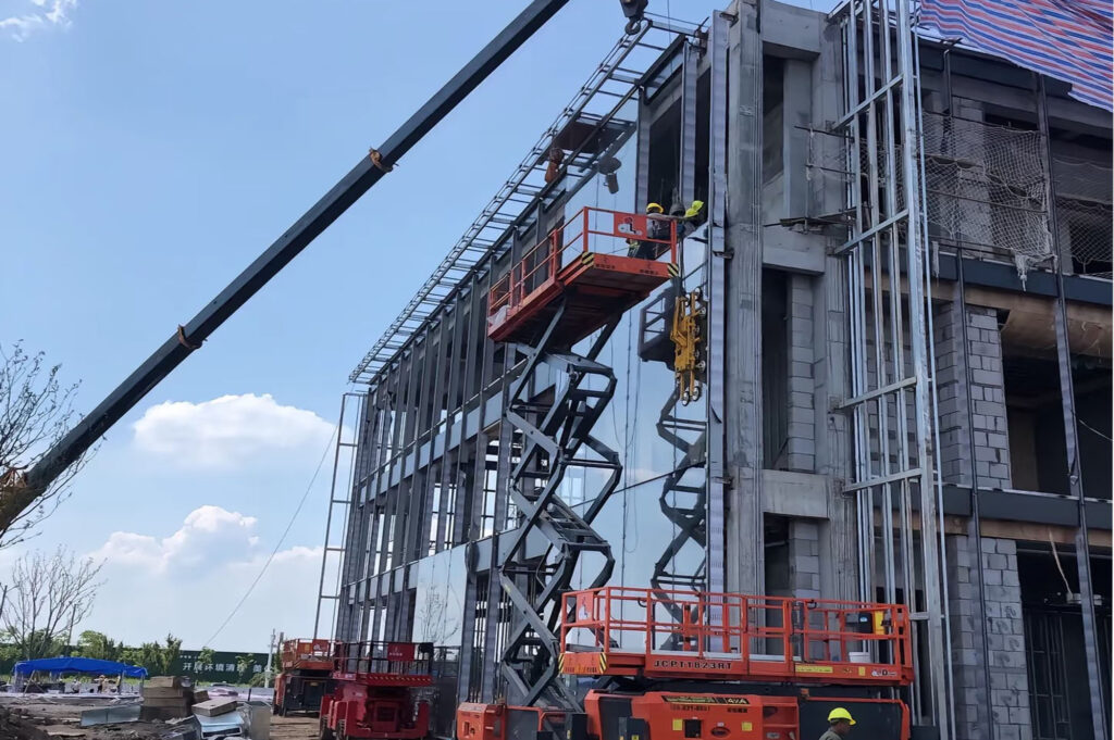 Facade glass lifting process on a modern building construction site